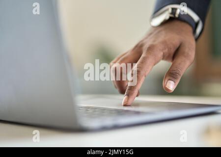 Business man wearing suit typing finger using laptop computer. Close up Stock Photo