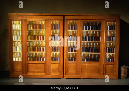 Different ages and colours of strong alcoholic apple drink calvados in Normandy, Calvados region, France, calvados tasting tour Stock Photo