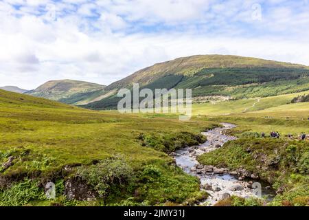 Fairy Pools Isle of Skye, tourists walking from the nearby carpark to the Fairy Pools on a summers day past the River Brittle,Scotland,UK,Europe Stock Photo