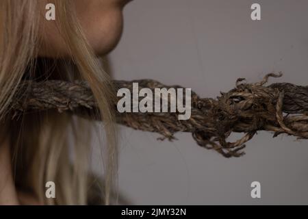 girl with a rope around her neck, human trafficking, slavery, power over people, a rope around a person's neck Stock Photo