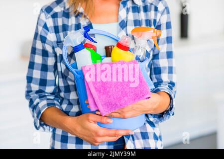 Mid section janitor holding cleaning equipments blue bucket Stock Photo