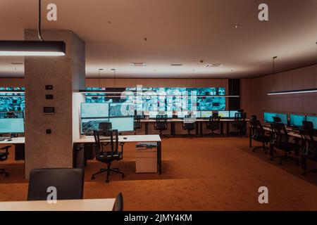 Empty interior of big modern security system control room, workstation with multiple displays, monitoring room with at security Stock Photo