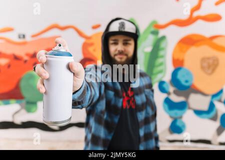 Man s hand holding white aerosol can Stock Photo