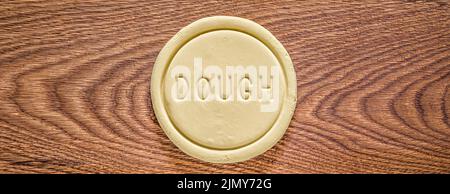 A piece of dough on an oak wood cutting board Stock Photo