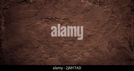 Dark chocolate brown sugar-like grainy texture background Stock Photo