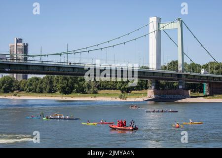 the Muelheim bridge over the Rhine, rowers and kayakers, Cologne, Germany. die Muelheimer Bruecke ueber den Rhein, Ruderer und Kajakfahrer, Koeln, Deu Stock Photo