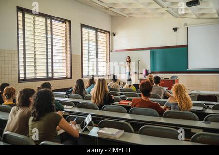 Lecturer talking to students during lesson Stock Photo