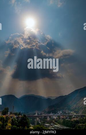sun rays and clouds in the blue sky Stock Photo