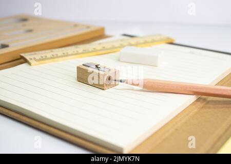 close up a pencil with pencil sharpener on paper and eraser ruler background Stock Photo