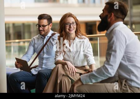 Happy group of young business people friends discussing brainstorming ideas at meeting Stock Photo