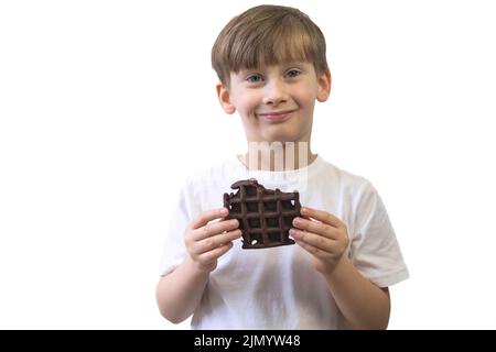 Happy boy with a chocolate waffle on a white background. Stock Photo
