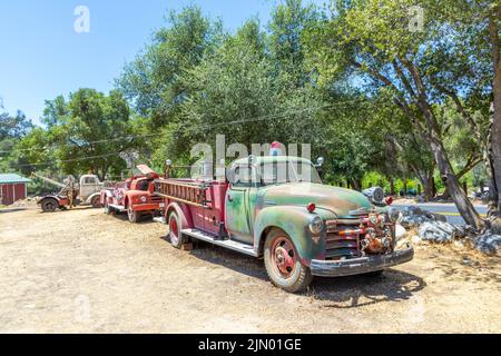 Three Rivers, USA - May 21, 2022: old vintage dirty  fire engine car at an outdoor loam parking lot in three rivers. Stock Photo