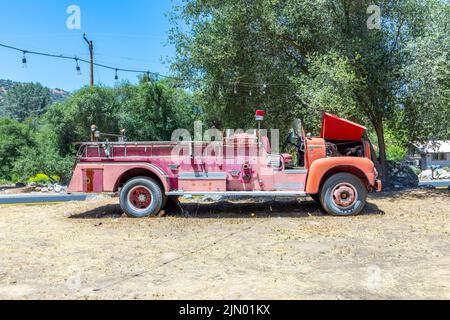 Three Rivers, USA - May 21, 2022: old vintage dirty  fire engine vintage car at an outdoor loam parking lot in three rivers. Stock Photo