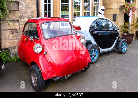 renault twizy and classic red bubble car outside the Crown pub in the ...