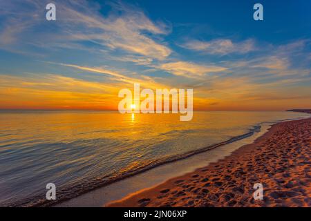 Beautiful summer sunset over beach at Baltic sea Stock Photo
