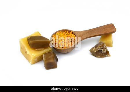 Bee products. Honey with dipper, bee pollen and natural wax isolated on white background. Stock Photo