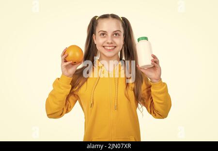 vitamin c. organic food supplement. choice between natural products and pills. presenting vitamin product. child with orange flavored pill. effervesce Stock Photo