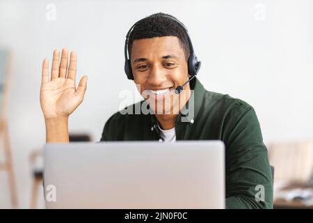 young man customer support call center operator or receptionist consulting a client uses a headset Stock Photo