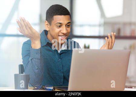 Man working using laptop Young businessman talking with colleagues or partners on video call Stock Photo