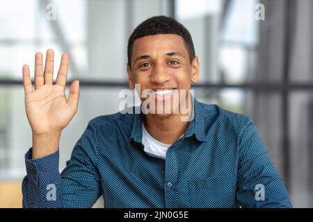 Remote work online interview video conference Video call Headshot of a positive male looking at the camera and smiling  Stock Photo