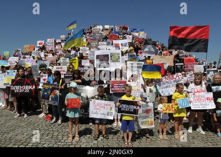 Dnipro, Ukraine. 07th Aug, 2022. DNIPRO, UKRAINE - AUGUST 07, 2022 - People hold flags and placards during the action in support of the Azovstal POWs at the Festival Pier to draw global attention to the russian terrorist attack in Olenivka, Dnipro, eastern Ukraine. This photo cannot be distributed in the russian federation. Credit: Ukrinform/Alamy Live News Stock Photo