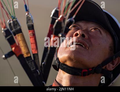 (220808) -- XINJIANG, Aug. 8, 2022 (Xinhua) -- Chen Ruifeng practices paragliding in southern suburb of Urumqi, northwest China's Xinjiang Uygur Autonomous Region, June 11, 2022. Born in Xinjiang, 52-year-old Chen Ruifeng is a paragliding amateur. He says he feels like having his own wings when the paraglider opens. In 2016, Chen Ruifeng started to practice paragliding. Later on, he joined a local club and received his flying certificate after training. As an outdoor enthusiast, he also engages himself in trail running, mountaineering and ice climbing. In his opinions, the unique terrain of Xi Stock Photo