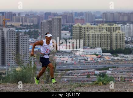 (220808) -- XINJIANG, Aug. 8, 2022 (Xinhua) -- Chen Ruifeng jogs in Urumqi, northwest China's Xinjiang Uygur Autonomous Region, June 14, 2022. Born in Xinjiang, 52-year-old Chen Ruifeng is a paragliding amateur. He says he feels like having his own wings when the paraglider opens. In 2016, Chen Ruifeng started to practice paragliding. Later on, he joined a local club and received his flying certificate after training. As an outdoor enthusiast, he also engages himself in trail running, mountaineering and ice climbing. In his opinions, the unique terrain of Xinjiang, such as mountains, steppes a Stock Photo