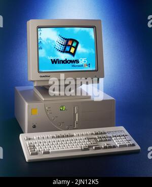 Brussels, Belgium - August 02, 2022:  Nineties obsolete tower pc computer and Windows 95 logo on screen. A old operating system from Microsoft Stock Photo