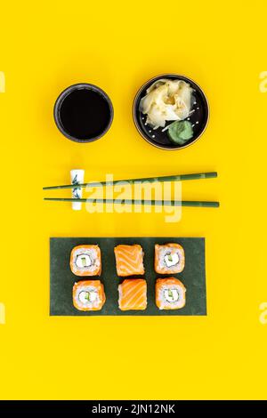 Sushi rolls set with salmon eco served on green papper plate, top view Stock Photo