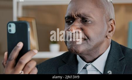 Closeup male portrait African American 50s old middle-aged businessman emotional professional man online remote conversation manager worker looking in Stock Photo
