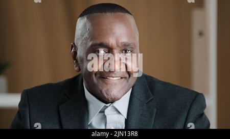 Portrait serious African old senior mature pensive businessman wrinkled male face thoughtful manager in office looking away thinking about problem Stock Photo