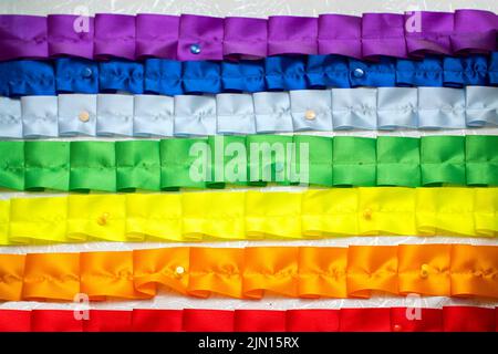Rainbow of folded nailed or pinned ribbons Stock Photo - Alamy