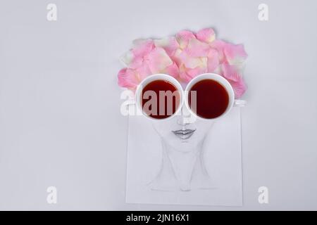 Hand drawn female face with petal hair. Cups of tea instead of eyes. Stock Photo