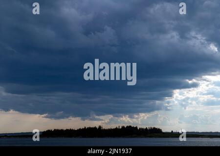 July 8, 2022.  5:47pm.  Storm clouds on the way.  View from Barnes Island.  Casco Bay, Maine. Rain Storm Series. Stock Photo