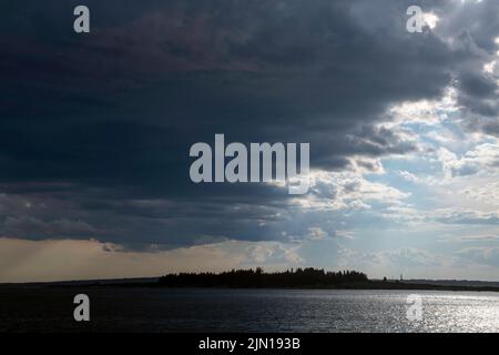 July 8, 2022.  5:55pm.  Storm clouds on the way.  View from Barnes Island.  Casco Bay, Maine. Rain Storm Series. Stock Photo