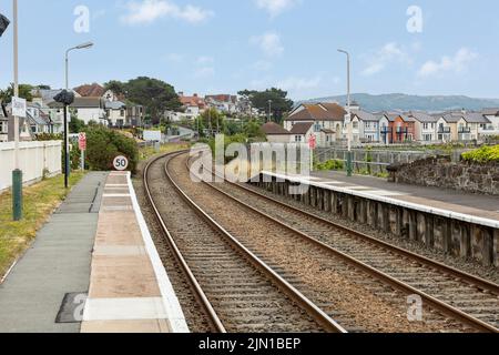 Deganwy  north Wales united kingdom 01 August 2022 railway tracks leading away from Deganwy train station 50 miles per hour speed limit Stock Photo