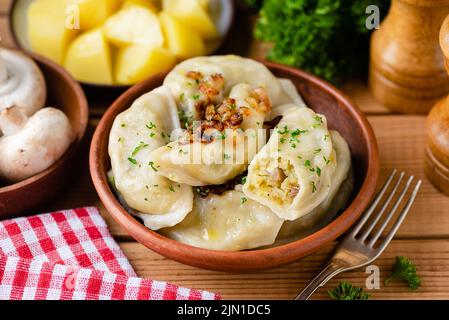 Potato mushroom stuffed vareniky, pierogi or dumplings. Ukrainian cuisine food Stock Photo