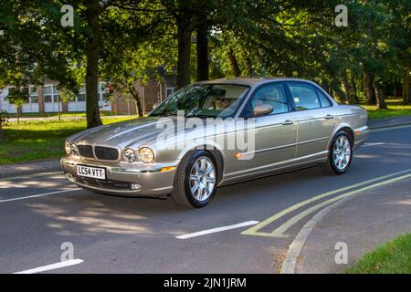 2004 Beige British Jaguar XJ V8 Sport petrol 3555cc 6-speed manual luxury automobile; Collectable cars are travelling to display at the 13th Lytham Hall Summer Classic Car & Motorcycle Show, a Classic Vintage Collectible Transport Festival. Stock Photo