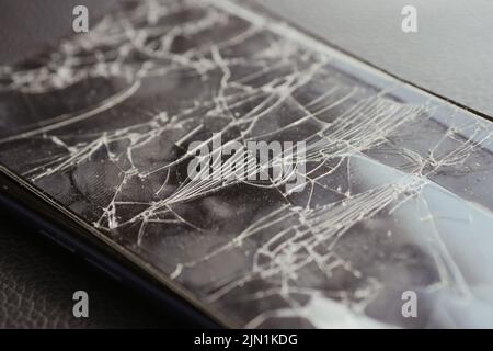 Top view of broken smart phone on color background  Stock Photo