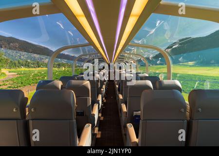 Interior of the gold leaf Rocky Mountaineer train wagon with tourists ...
