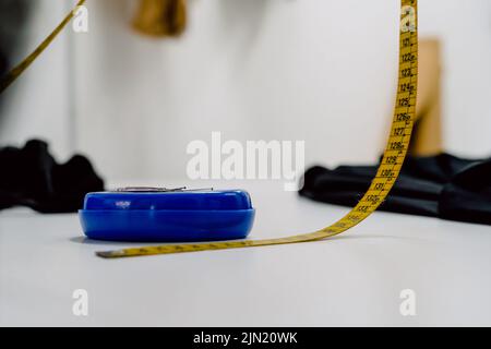 yellow meter for sewing and box of blue needles Stock Photo