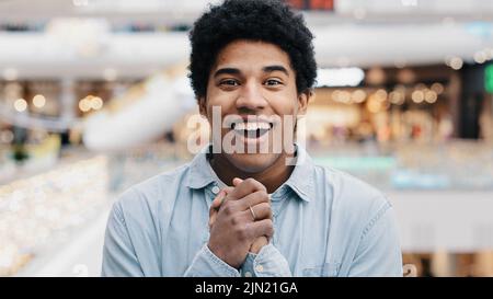 Front view portrait emotions enthusiastic surprised shocked amazed man african american guy teen looking at camera opens mouth and eyes in surprise Stock Photo