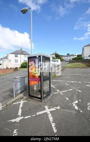 Dunure, Ayrshire, Scotland, UK. Former telephone box kiosk now converted to hold a defibrillator in the small coastal village. Located in a small car park Stock Photo