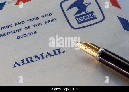 Vintage airmail stamped envelop and fountain pen close up, USA Stock Photo