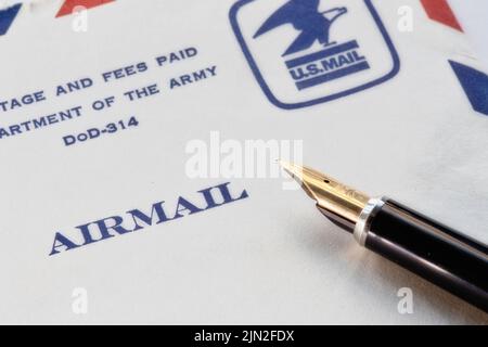 Vintage airmail stamped envelop and fountain pen close up, USA Stock Photo