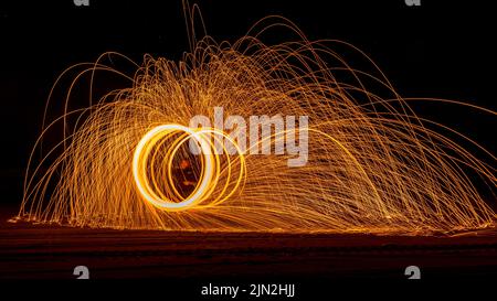 Night photography of light painting on the beach with the milky way in the background. Stock Photo