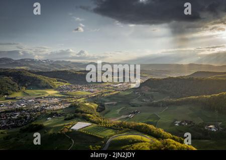 Aerial drone photograph of a sunset behind a rainy storm cloud Stock Photo