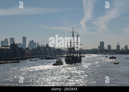 Tall ship Götheborg of Sweden makes way towards her berth in South Dock, Canary Wharf after passing through Tower Bridge, escorted by tug Christine. Stock Photo