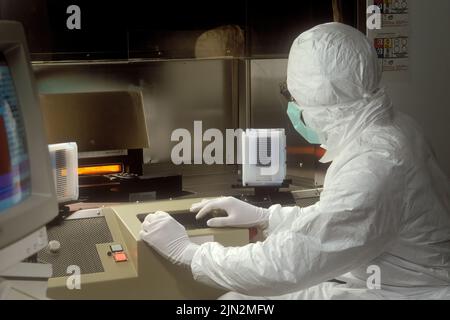 A person in a clean room researching computer microchip wafer manufacture Stock Photo