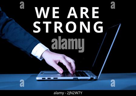 Text caption presenting We Are Strong. Word Written on Have great strength healthy powerful achieving everything Businesswoman Typing Recent Updates Stock Photo